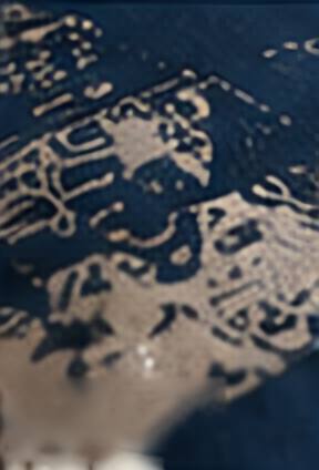 Detail of a cream screen-printed pattern on deep blue stock.