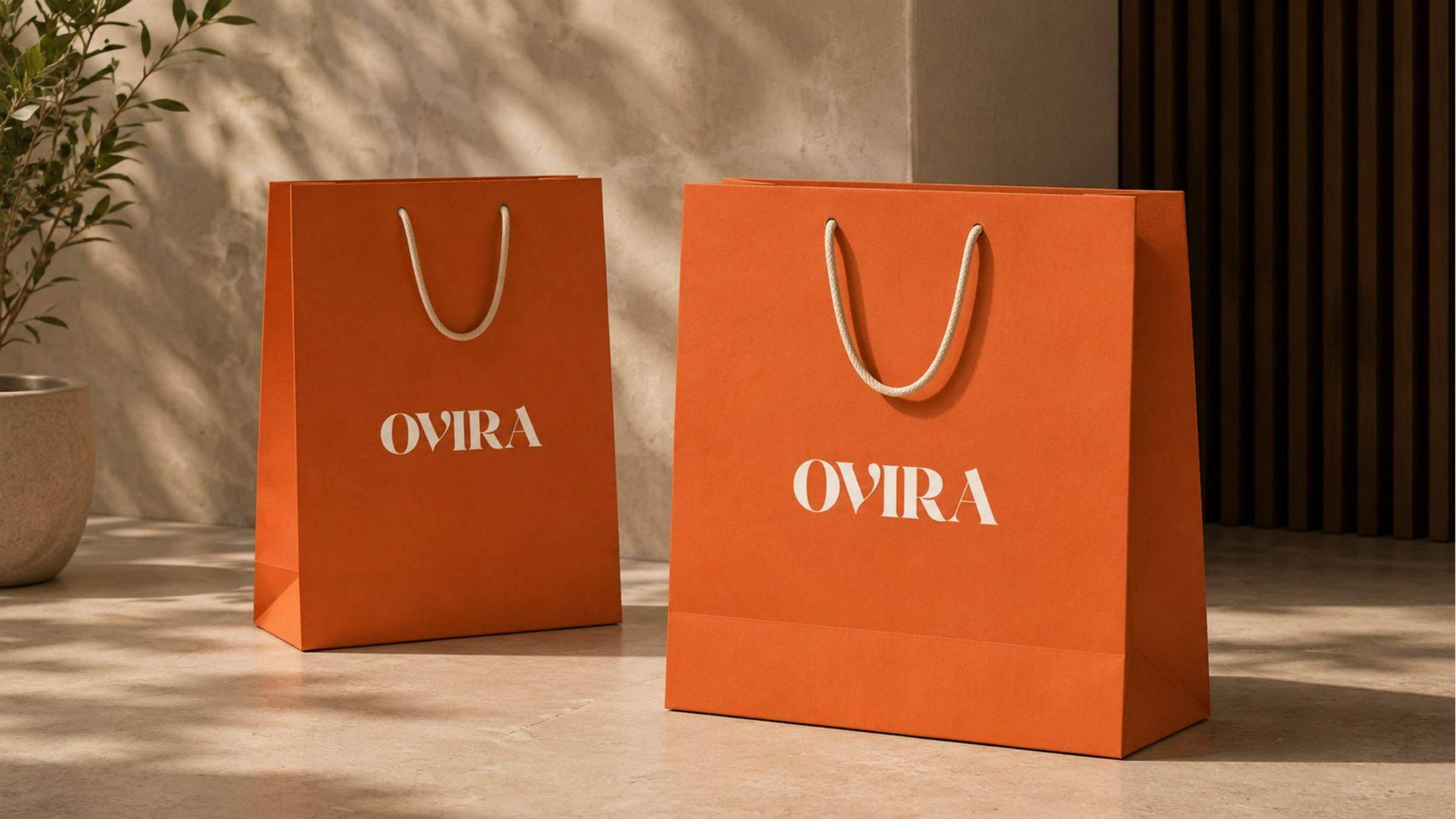 Branded paper gift bags for Ovira Ayurveda in terracotta.