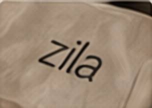 A Zila paper napkin printed with the wordmark.